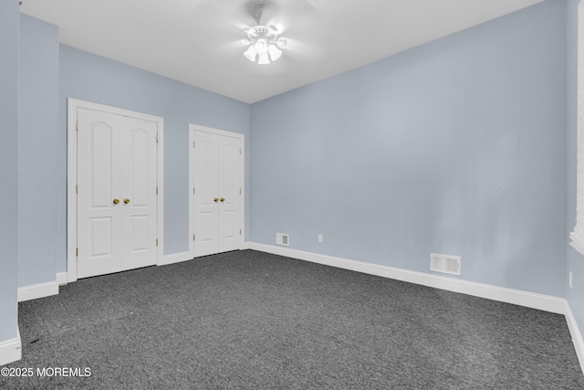25 Rockefeller Dr, Lakewood, NJ 08701 - unfurnished bedroom with dark colored carpet and two closets