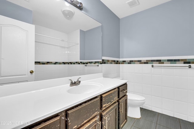 25 Rockefeller Dr, Lakewood, NJ 08701 - bathroom featuring tile walls, vanity, tile patterned floors, and wainscoting