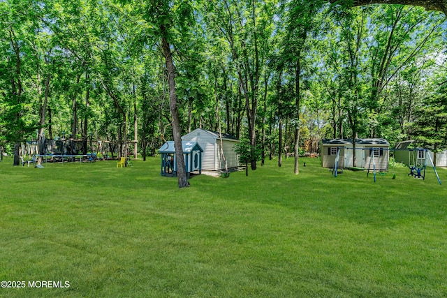 25 Rockefeller Dr, Lakewood, NJ 08701 - view of grassy yard with a storage unit and a trampoline