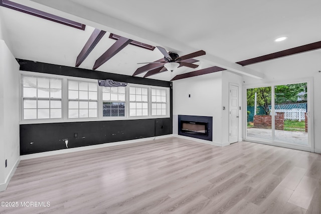 215 Sunset Ln, Howell, NJ 07731 - unfurnished living room with beam ceiling, a glass covered fireplace, wood finished floors, ceiling fan, and recessed lighting