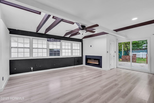 215 Sunset Ln, Howell, NJ 07731 - unfurnished living room with beamed ceiling, a glass covered fireplace, wood finished floors, a ceiling fan, and recessed lighting