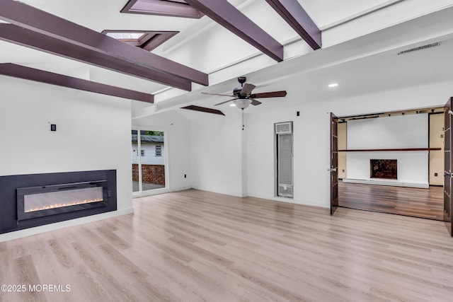 215 Sunset Ln, Howell, NJ 07731 - unfurnished living room with a glass covered fireplace, beam ceiling, wood finished floors, recessed lighting, and a ceiling fan