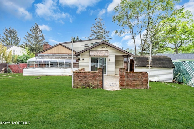 215 Sunset Ln, Howell, NJ 07731 - back of house featuring a sunroom, a shed, a lawn, a chimney, and a patio area