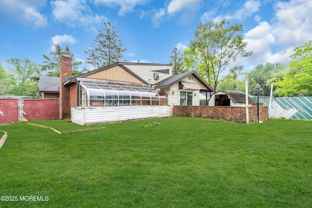 215 Sunset Ln, Howell, NJ 07731 - back of house featuring a sunroom, a chimney, and a storage shed