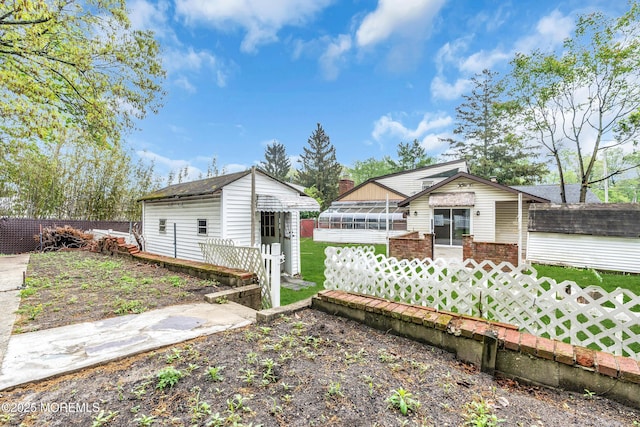 215 Sunset Ln, Howell, NJ 07731 - rear view of property featuring an outdoor structure and a sunroom