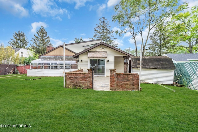 215 Sunset Ln, Howell, NJ 07731 - back of house featuring a lawn, a shed, a sunroom, and a patio