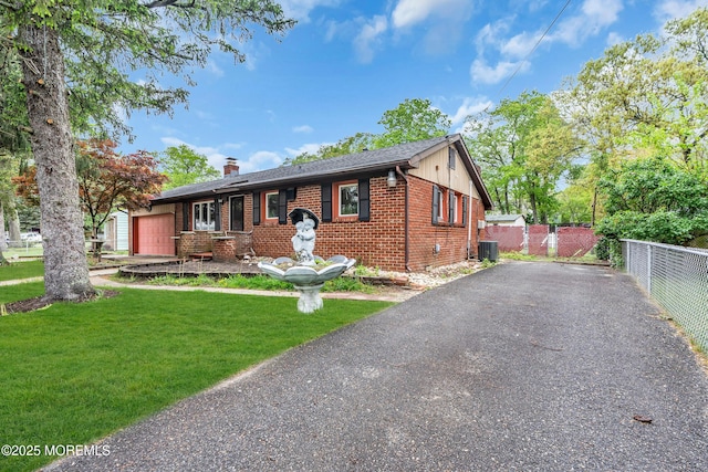 215 Sunset Ln, Howell, NJ 07731 - view of front facade featuring brick siding, a chimney, a garage, and driveway