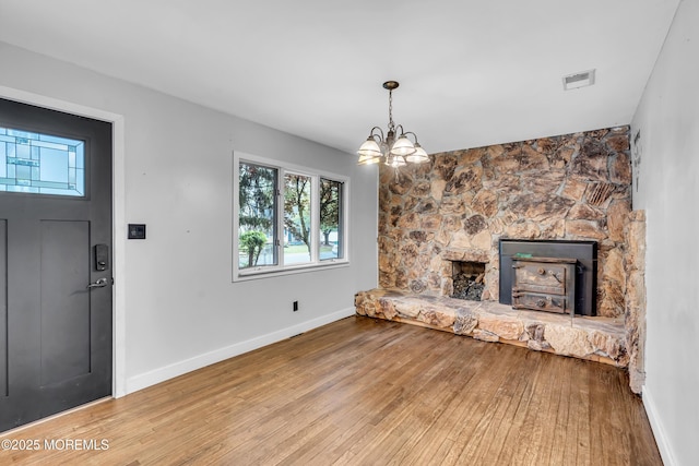 215 Sunset Ln, Howell, NJ 07731 - unfurnished living room featuring wood finished floors and a chandelier