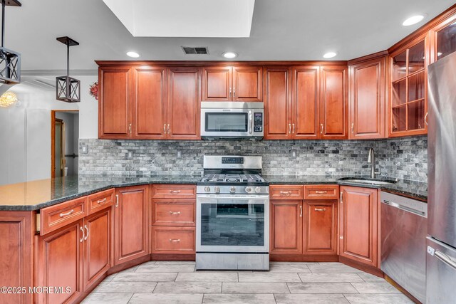 215 Sunset Ln, Howell, NJ 07731 - kitchen featuring appliances with stainless steel finishes, recessed lighting, brown cabinetry, dark stone countertops, and glass insert cabinets