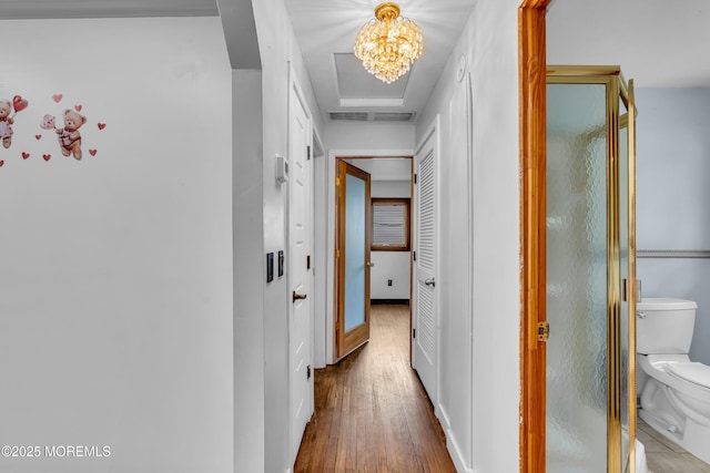 215 Sunset Ln, Howell, NJ 07731 - corridor with wood finished floors and a chandelier
