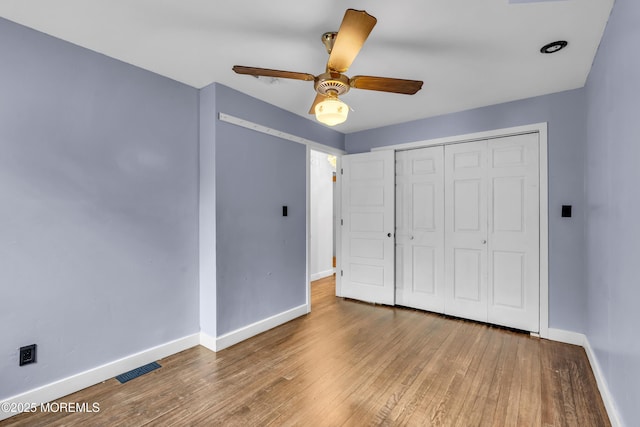215 Sunset Ln, Howell, NJ 07731 - unfurnished bedroom featuring hardwood / wood-style floors, a closet, and a ceiling fan