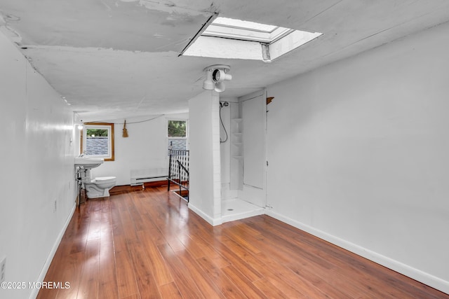 215 Sunset Ln, Howell, NJ 07731 - hallway with wood finished floors and a skylight