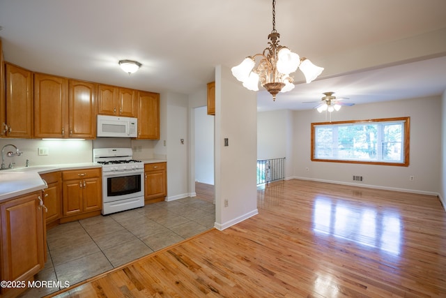 2152 Dover Pines Ave, Toms River, NJ 08755 - kitchen featuring white appliances, light wood-style floors, light countertops, a ceiling fan, and a chandelier