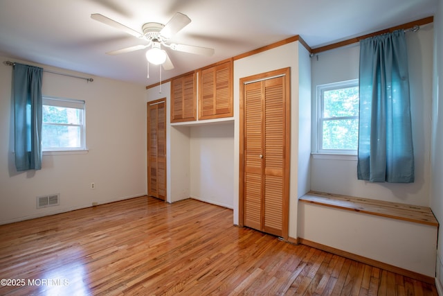 2152 Dover Pines Ave, Toms River, NJ 08755 - unfurnished bedroom with multiple closets, light wood-type flooring, and ceiling fan