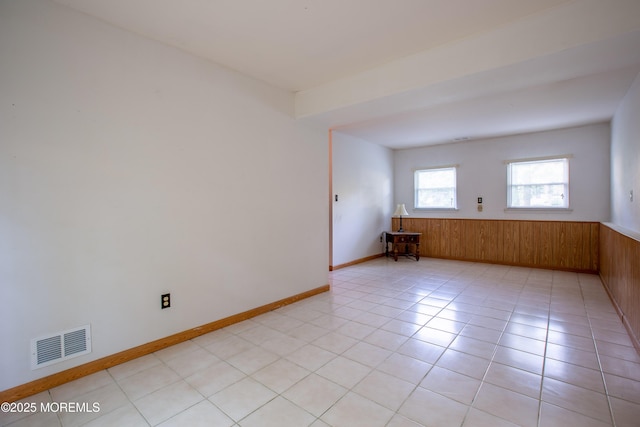 2152 Dover Pines Ave, Toms River, NJ 08755 - unfurnished room featuring wainscoting, light tile patterned flooring, and wood walls