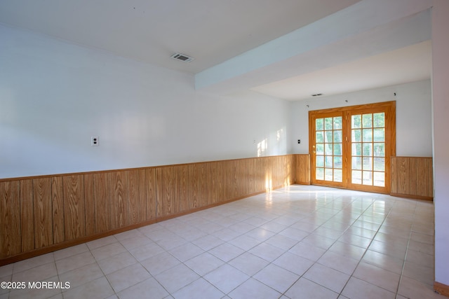 2152 Dover Pines Ave, Toms River, NJ 08755 - unfurnished room with a wainscoted wall, wood walls, and light tile patterned floors