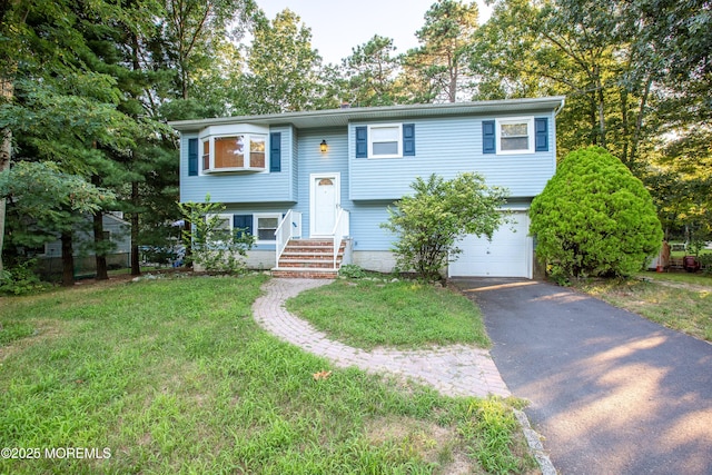2152 Dover Pines Ave, Toms River, NJ 08755 - split foyer home featuring a garage, driveway, and a front lawn