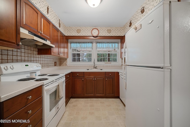 446 Steuben Ave, Forked River, NJ 08731 - kitchen with white appliances, under cabinet range hood, light countertops, backsplash, and brown cabinetry