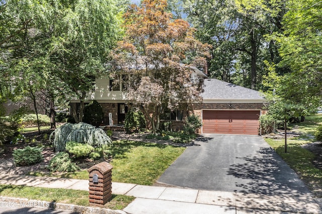 27 Darby Rd, East Brunswick, NJ 08816 - obstructed view of property featuring driveway, a garage, brick siding, and a front yard