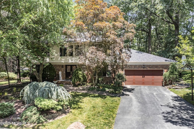 27 Darby Rd, East Brunswick, NJ 08816 - obstructed view of property with brick siding, asphalt driveway, an attached garage, and roof with shingles