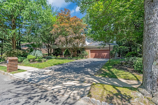 27 Darby Rd, East Brunswick, NJ 08816 - obstructed view of property featuring driveway and brick siding