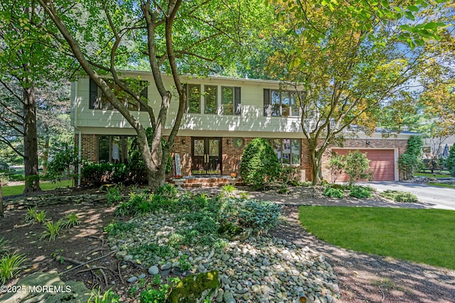 27 Darby Rd, East Brunswick, NJ 08816 - colonial house with brick siding, driveway, french doors, and a garage