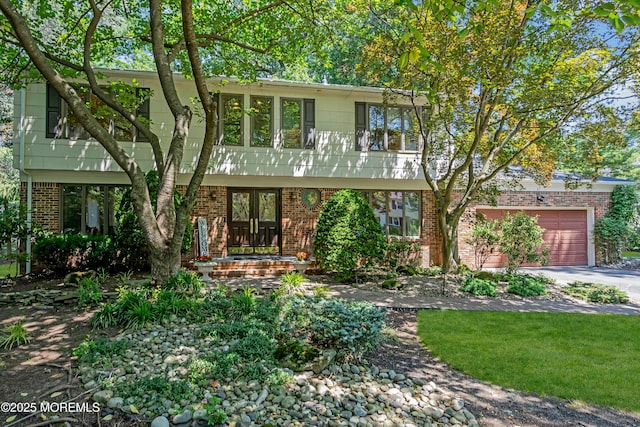 27 Darby Rd, East Brunswick, NJ 08816 - colonial inspired home featuring driveway, brick siding, a garage, and french doors
