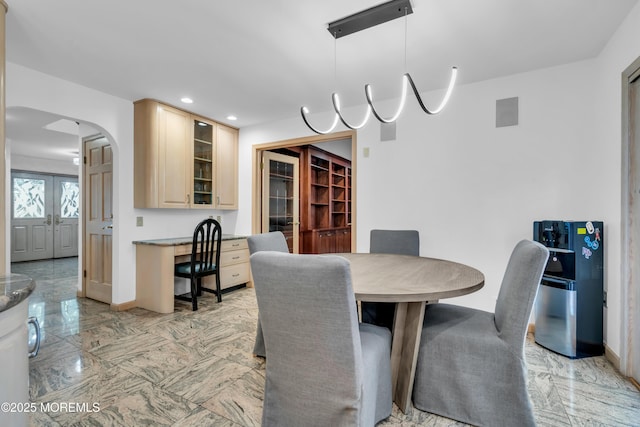 27 Darby Rd, East Brunswick, NJ 08816 - dining space with arched walkways, light marble finish floors, recessed lighting, and french doors
