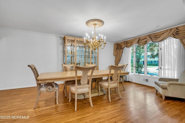 27 Darby Rd, East Brunswick, NJ 08816 - dining area with a chandelier, light wood finished floors, and ornamental molding