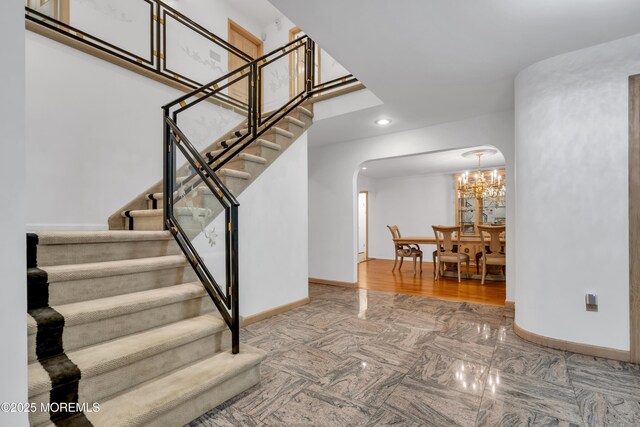 27 Darby Rd, East Brunswick, NJ 08816 - stairs with arched walkways, a chandelier, and recessed lighting