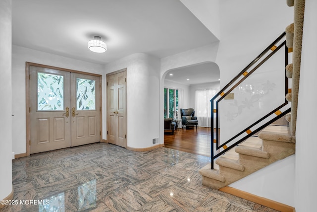 27 Darby Rd, East Brunswick, NJ 08816 - foyer entrance with arched walkways, stairway, french doors, and recessed lighting