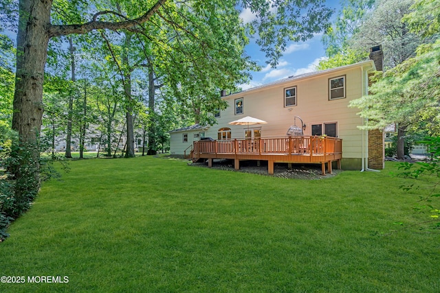 27 Darby Rd, East Brunswick, NJ 08816 - rear view of house featuring a chimney, a deck, and a lawn