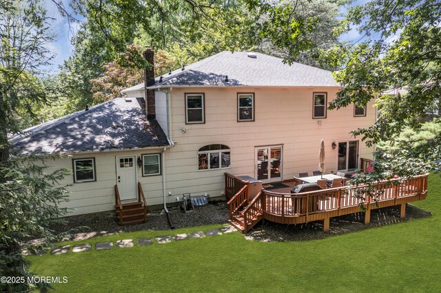 27 Darby Rd, East Brunswick, NJ 08816 - back of property featuring roof with shingles, entry steps, a lawn, a deck, and a chimney