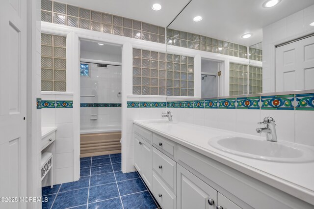 27 Darby Rd, East Brunswick, NJ 08816 - full bathroom with tile walls, double vanity, tile patterned floors, enclosed tub / shower combo, and recessed lighting