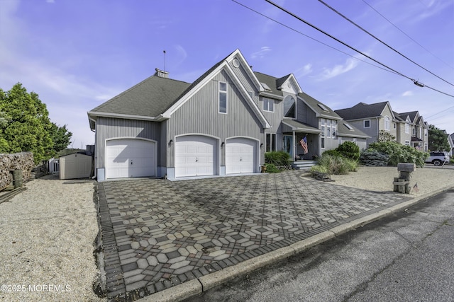 1030 Montauk Dr, Forked River, NJ 08731 - view of front of house with decorative driveway, a residential view, roof with shingles, and an attached garage