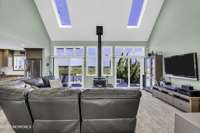 1030 Montauk Dr, Forked River, NJ 08731 - living area with a skylight, a wood stove, high vaulted ceiling, light carpet, and plenty of natural light