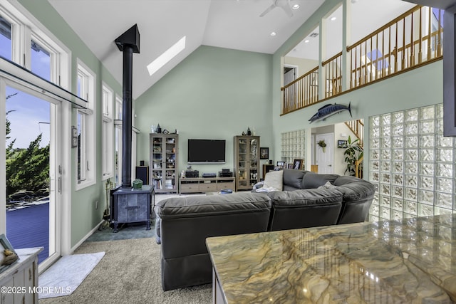 1030 Montauk Dr, Forked River, NJ 08731 - carpeted living room featuring a wood stove, high vaulted ceiling, a ceiling fan, and recessed lighting