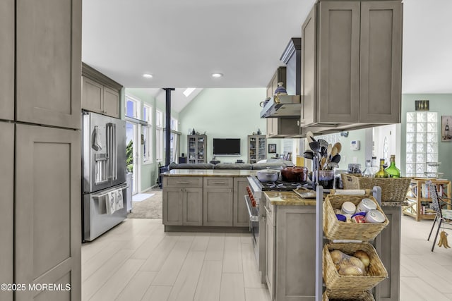 1030 Montauk Dr, Forked River, NJ 08731 - kitchen featuring premium appliances, a peninsula, open floor plan, stone countertops, and vaulted ceiling