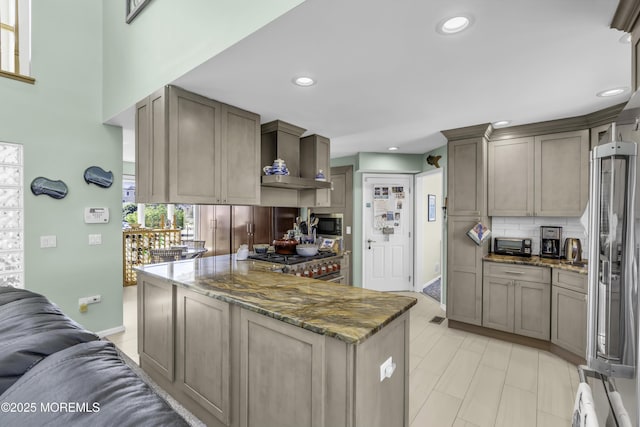 1030 Montauk Dr, Forked River, NJ 08731 - kitchen with wall chimney range hood, high end appliances, backsplash, dark stone counters, and recessed lighting