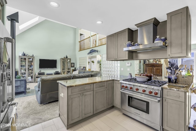 1030 Montauk Dr, Forked River, NJ 08731 - kitchen with wall chimney exhaust hood, luxury range, a peninsula, light stone countertops, and decorative backsplash