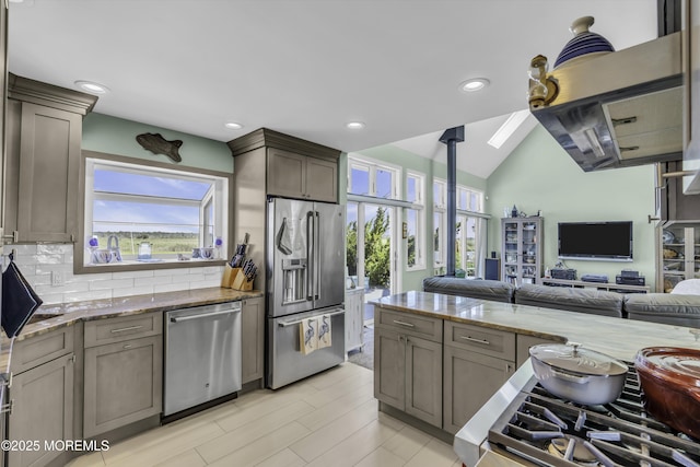 1030 Montauk Dr, Forked River, NJ 08731 - kitchen featuring stainless steel appliances, healthy amount of natural light, open floor plan, light stone countertops, and vaulted ceiling