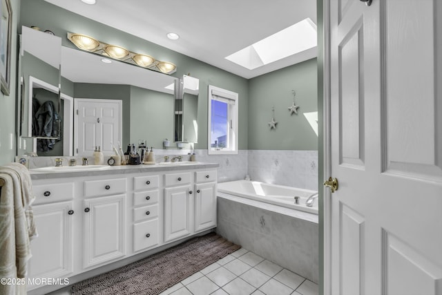 1030 Montauk Dr, Forked River, NJ 08731 - full bath featuring a skylight, double vanity, tile patterned floors, a bath, and recessed lighting