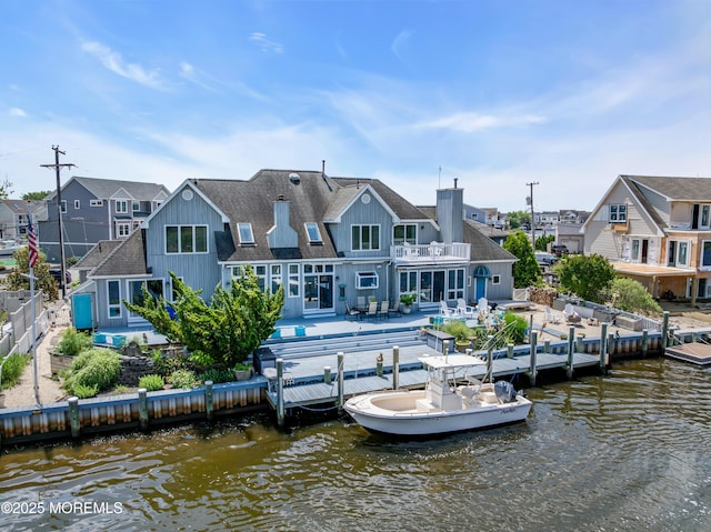 1030 Montauk Dr, Forked River, NJ 08731 - rear view of property featuring a balcony, board and batten siding, a fenced backyard, and roof with shingles