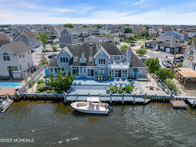 1030 Montauk Dr, Forked River, NJ 08731 - back of property with a residential view, a fenced backyard, a water view, and roof with shingles
