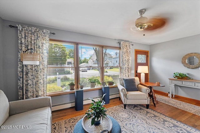 3100 Harrison St, Wall, NJ 07719 - sitting room featuring a baseboard heating unit, wood finished floors, and a ceiling fan