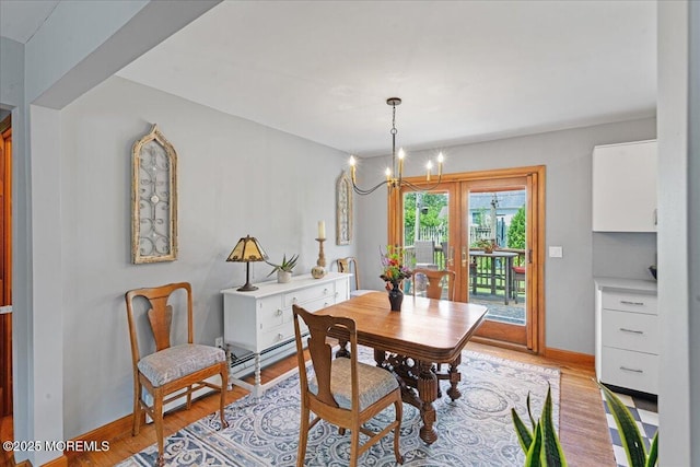 3100 Harrison St, Wall, NJ 07719 - dining area featuring a baseboard heating unit, a chandelier, and light wood-type flooring