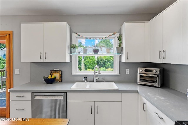 3100 Harrison St, Wall, NJ 07719 - kitchen featuring stainless steel dishwasher, light countertops, white cabinetry, and decorative backsplash