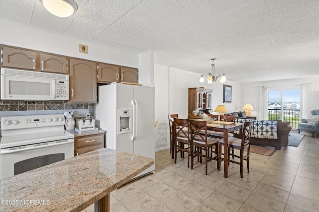 51 Hiering Ave Unit D9, Seaside Heights, NJ 08751 - kitchen with white appliances, open floor plan, a chandelier, decorative backsplash, and hanging light fixtures