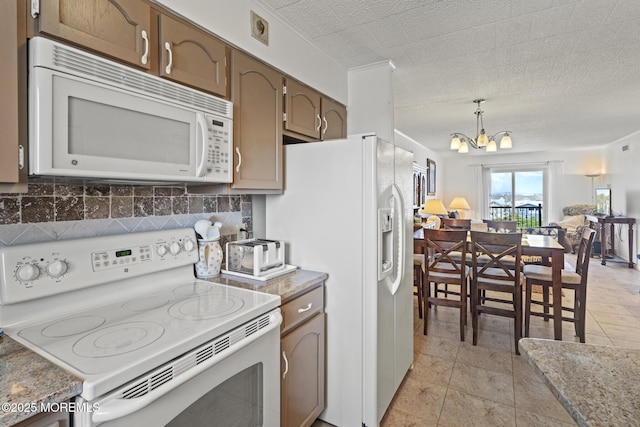 51 Hiering Ave Unit D9, Seaside Heights, NJ 08751 - kitchen featuring white appliances, a chandelier, tasteful backsplash, decorative light fixtures, and light countertops