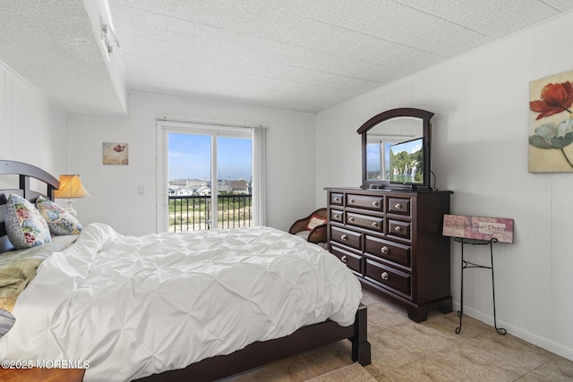 51 Hiering Ave Unit D9, Seaside Heights, NJ 08751 - bedroom with access to outside, a textured ceiling, and light tile patterned flooring